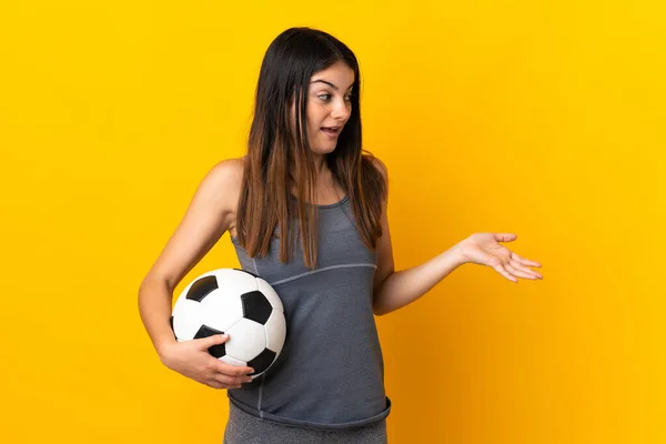 Young Football Player Woman Isolated Yellow Background Surprise Expression While — стоковое фото