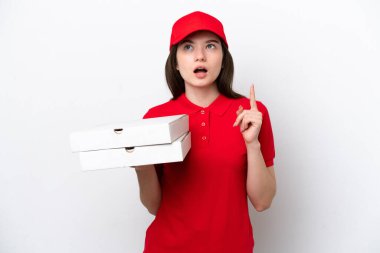 Young Russian pizza delivery picking up pizza boxes isolated on white background thinking an idea pointing the finger up