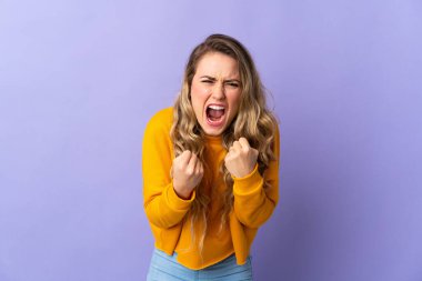 Young Brazilian woman isolated on purple background frustrated by a bad situation