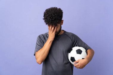 Handsome Moroccan young football player man over isolated on purple background with tired and sick expression
