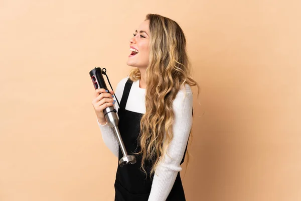 Young Brazilian Woman Using Hand Blender Isolated Beige Background Laughing — Stock Fotó