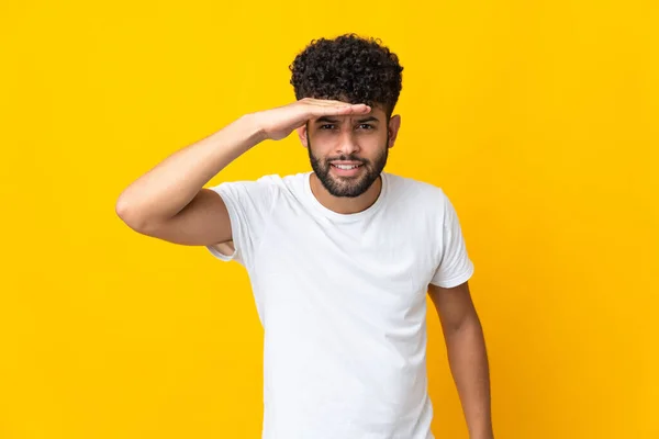 Young Moroccan Man Isolated Yellow Background Looking Far Away Hand — Stockfoto