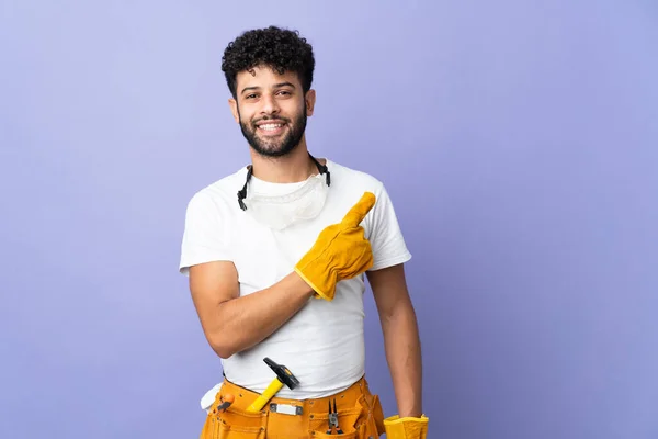 Young Electrician Moroccan Man Isolated Purple Background Pointing Side Present — Stock Fotó