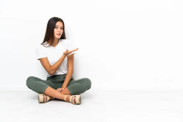 Adolescente Chica Sentada Suelo Presentando Una Idea Mientras Mira Sonriendo — Foto de Stock