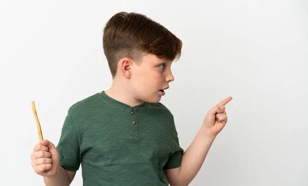 Menino Ruivo Segurando Uma Escova Dentes Isolada Fundo Branco Surpreso — Fotografia de Stock