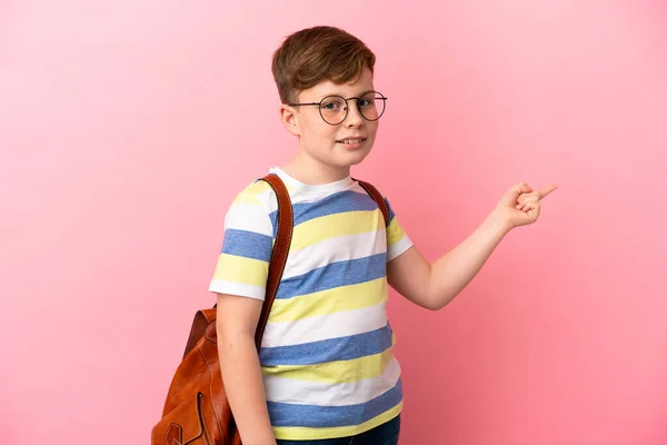 Little Redhead Caucasian Boy Isolated Pink Background Pointing Finger Side — Stock Photo, Image