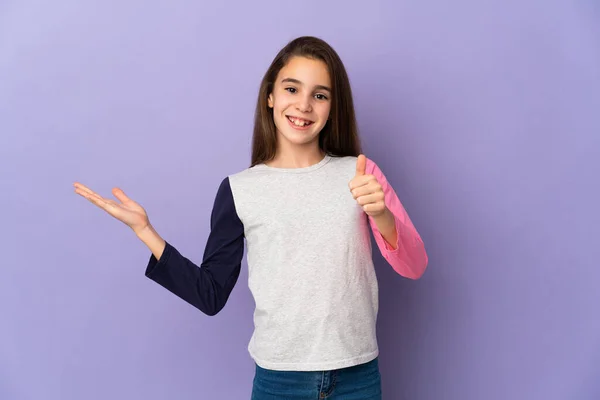 Little Girl Isolated Purple Background Holding Copyspace Imaginary Palm Insert — Stock Photo, Image