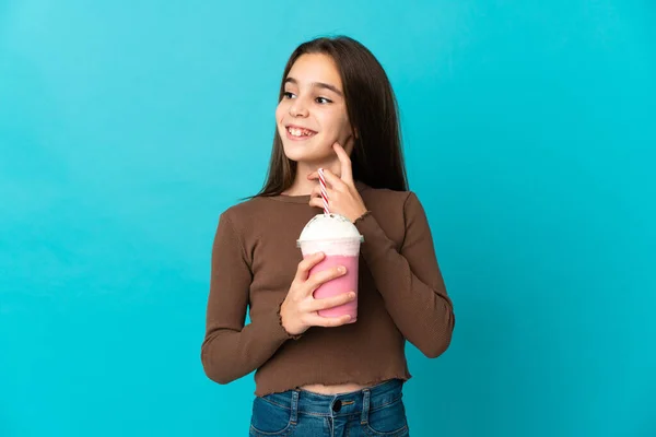 Liten Flicka Med Jordgubbsmjölkshake Isolerad Blå Bakgrund Tänker Idé Medan — Stockfoto