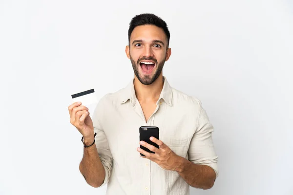 Joven Hombre Caucásico Aislado Sobre Fondo Blanco Comprando Con Móvil —  Fotos de Stock