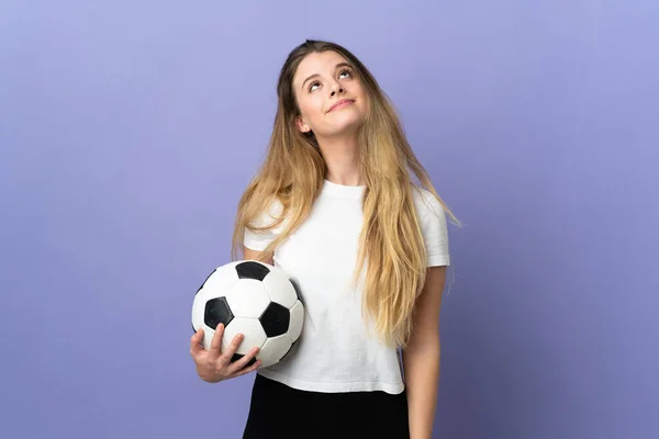 若いですブロンドサッカー選手女性隔離された上に紫の背景と見上げます — ストック写真