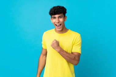 Arjantinli genç adam arka planda izole edilmiş zaferi kutluyor.