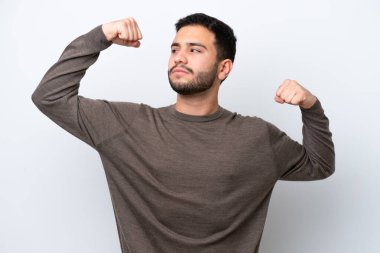 Beyaz arka planda izole edilmiş genç Brezilyalı adam güçlü bir jest yapıyor.