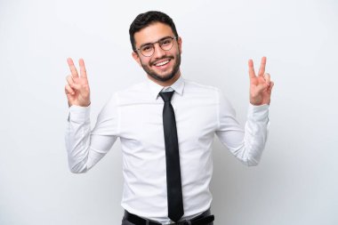 Beyaz arka planda izole edilmiş Brezilyalı bir adam zafer işaretini iki eliyle gösteriyor.