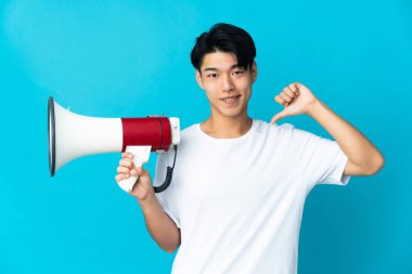 Mavi arka planda yalnız yaşayan genç bir Çinli elinde megafonla gururlu ve kendini beğenmiş bir adam.