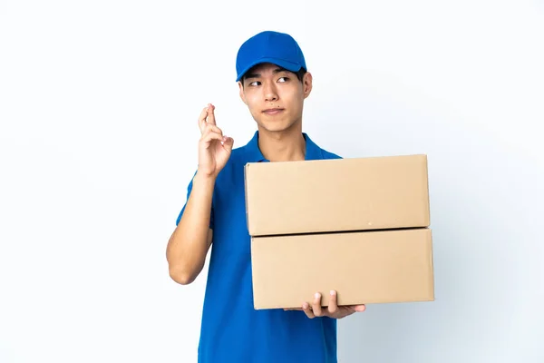Delivery Chinese Man Isolated White Background Fingers Crossing Wishing Best — Fotografia de Stock