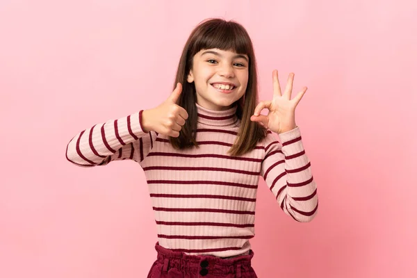 Little Girl Isolated Pink Background Showing Sign Thumb Gesture — Stockfoto