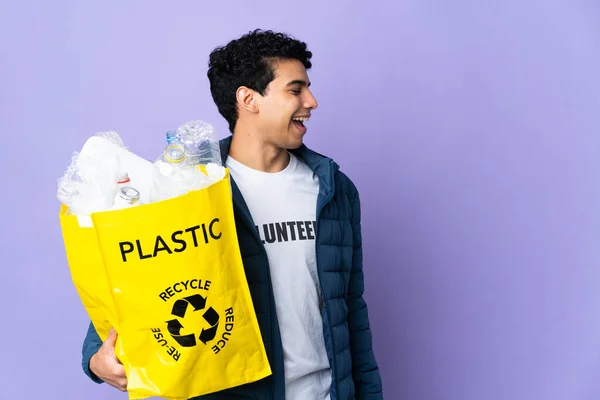 Молодий Венесуельський Чоловік Тримає Сумку Пластиковими Пляшками Сміється Бічній Позиції — стокове фото