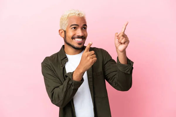 Young Colombian Handsome Man Isolated Pink Background Pointing Index Finger — Stock Photo, Image