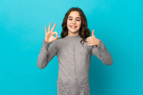 Little Caucasian Girl Isolated Blue Background Showing Sign Thumb Gesture — Stock Photo, Image