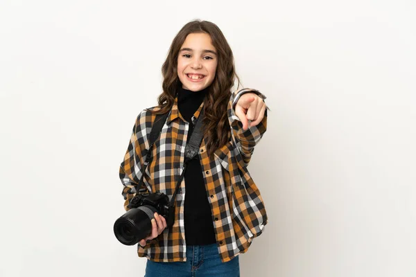 Little photographer girl isolated on background pointing front with happy expression