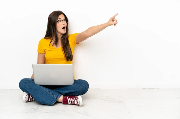 Junge Frau Mit Laptop Sitzt Auf Dem Boden Und Zeigt — Stockfoto