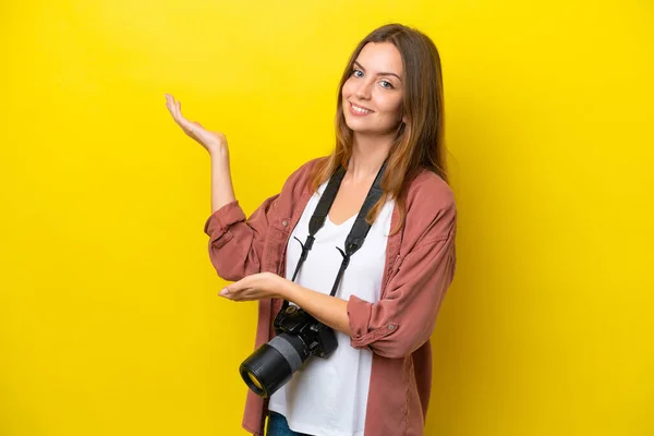 Young Photographer Caucasian Woman Isolated Yellow Background Extending Hands Side — Stock Photo, Image