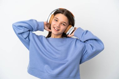 Küçük kız izole edilmiş beyaz arka planda müzik dinliyor.