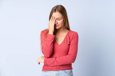 Genç Ukraynalı kız mavi arka planda baş ağrısı ile izole edilmiş.