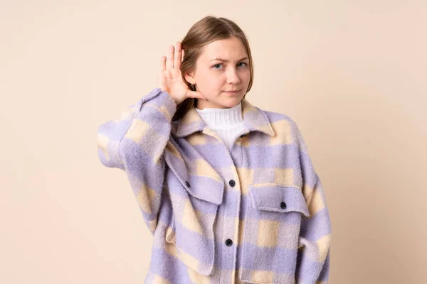 Teenager Ukrainian Girl Isolated Beige Background Listening Something Putting Hand — Zdjęcie stockowe
