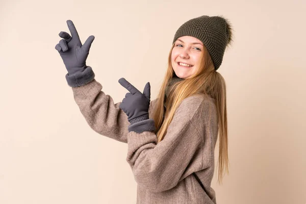 Tonåring Ukrainska Flicka Med Vinter Hatt Isolerad Beige Bakgrund Pekar — Stockfoto