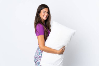 Genç Brezilyalı kız pijamalarıyla beyaz arka planda izole edilmiş ve çok gülümsüyor.