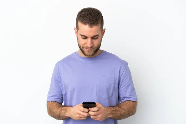 Young Handsome Caucasian Man Isolated White Background Using Mobile Phone — Zdjęcie stockowe