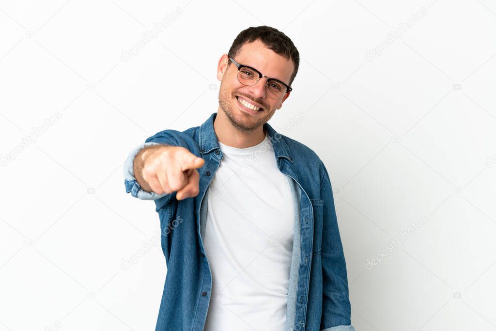 Brazilian man over isolated white background pointing front with happy expression