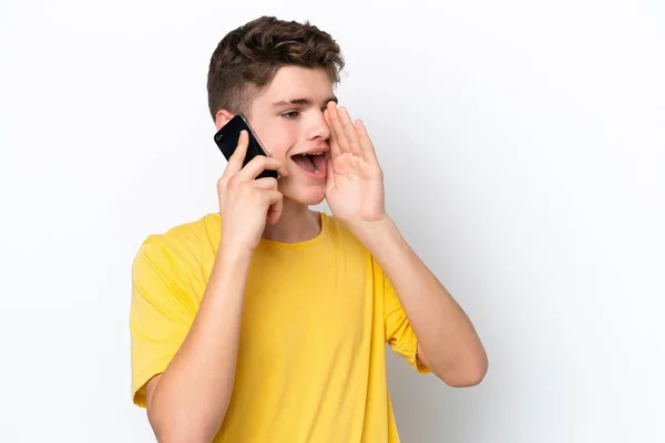 Teenager Man Using Mobile Phone Isolated White Background Shouting Mouth — Stock Photo, Image