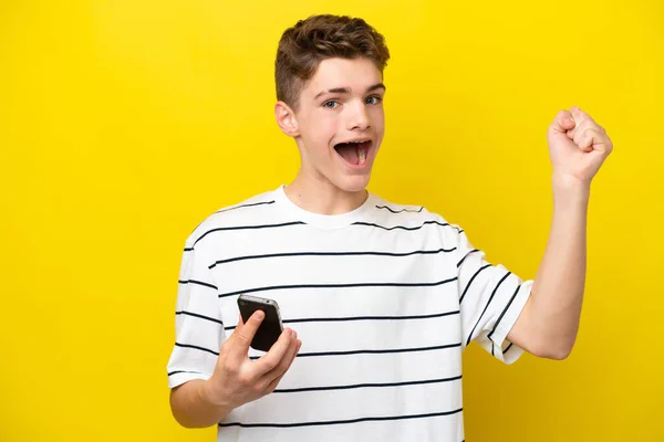 Teenager Russian Man Isolated Yellow Background Using Mobile Phone Doing — Stock Photo, Image