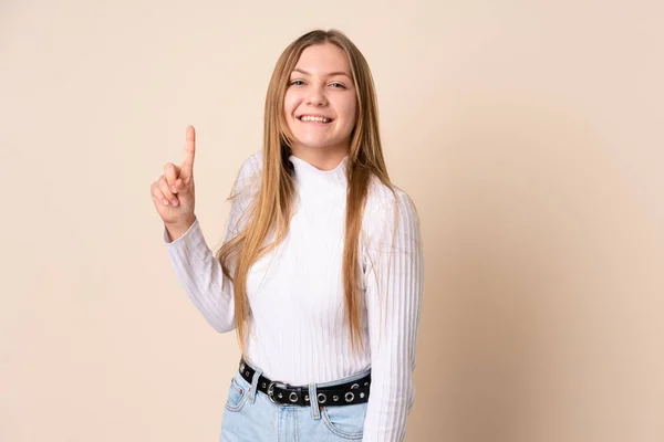 Teenager Ουκρανικό Κορίτσι Απομονώνονται Μπεζ Φόντο Δείχνει Και Σηκώνοντας Ένα — Φωτογραφία Αρχείου