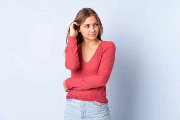 Teenager Ukrainian Girl Isolated Blue Background Having Doubts — Stock Photo, Image