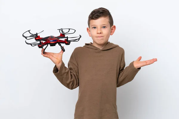 Little Caucasian Boy Holding Drone Isolated White Background Having Doubts — Stock Photo, Image
