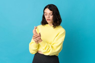 Genç Ukraynalı kız mavi arka planda izole edilmiş.