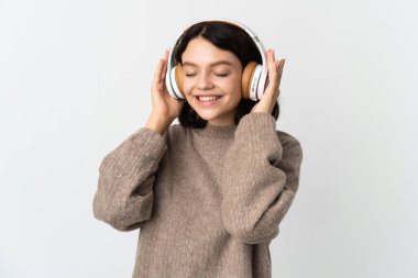 Genç Ukraynalı kız beyaz arka planda izole edilmiş müzik dinliyor.