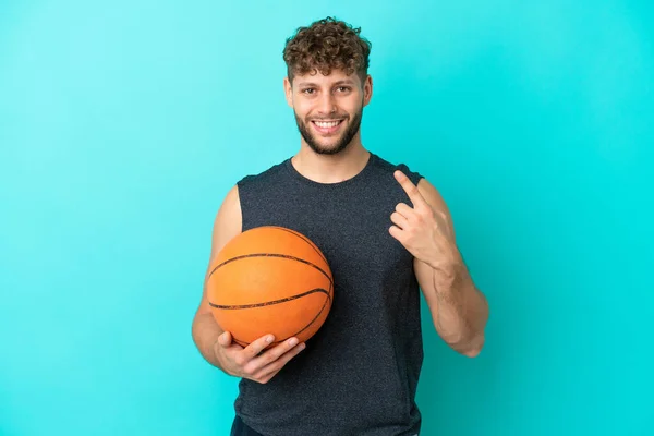 Guapo Joven Jugando Baloncesto Aislado Sobre Fondo Azul Dando Gesto —  Fotos de Stock