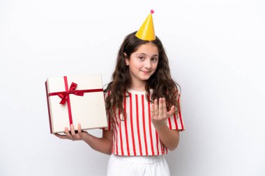 Doğum günü şapkalı kız elinde beyaz arka planda hediye kutusu tutuyor. 
