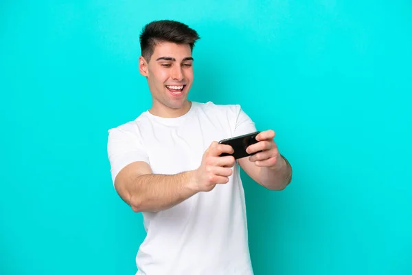 Junger Kaukasischer Mann Isoliert Auf Blauem Hintergrund Beim Spielen Mit — Stockfoto