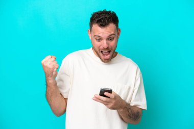 Mavi arka planda kalan Brezilyalı genç adam şaşırdı ve bir mesaj gönderiyor.