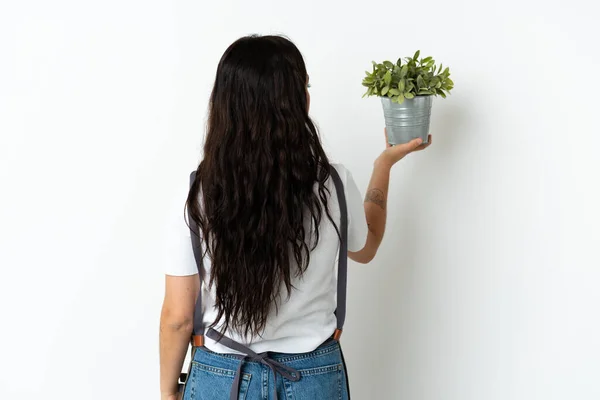 Junge Kaukasische Frau Hält Eine Pflanze Isoliert Auf Weißem Hintergrund — Stockfoto