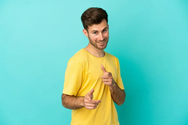 Young Caucasian Handsome Man Isolated Blue Background Pointing Front Smiling — Stock Photo, Image