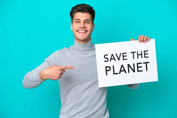 Jovem Caucasiano Bonito Isolado Chão Azul Segurando Cartaz Com Texto — Fotografia de Stock