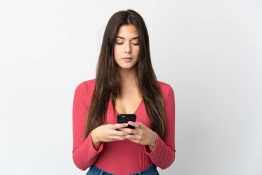 Genç Brezilyalı kız cep telefonu kullanarak beyaz arka planda izole edilmiş.