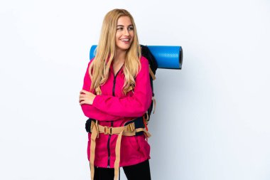 Genç dağcı kadın, izole edilmiş beyaz arka planda büyük bir sırt çantasıyla gülüyor.