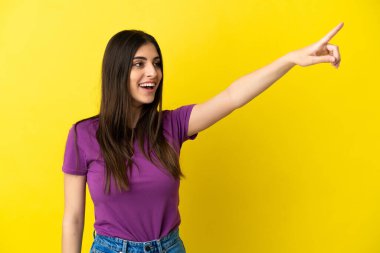 Sarı arka planda izole edilmiş genç beyaz kadın...